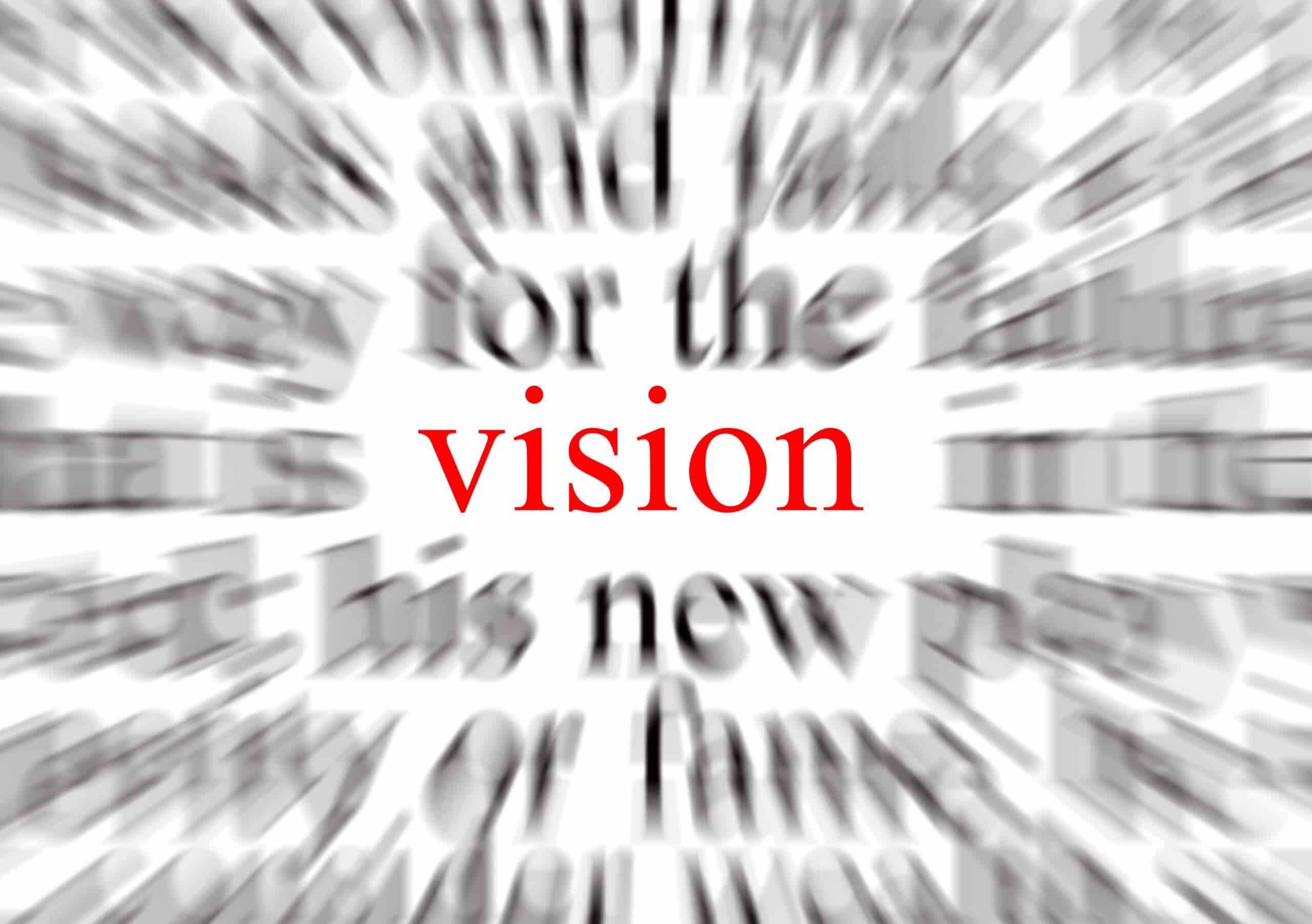 The word vision is in sharp focus in red letters at the centre, surrounded by blurred black text, creating a zoom effect that emphasises the central word.