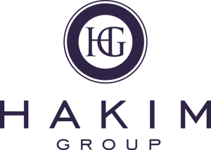 Logo of Hakim Group featuring a dark circle with HG in the center. The word HAKIM is written in large letters below, with GROUP in smaller letters underneath. The overall color scheme is dark blue.