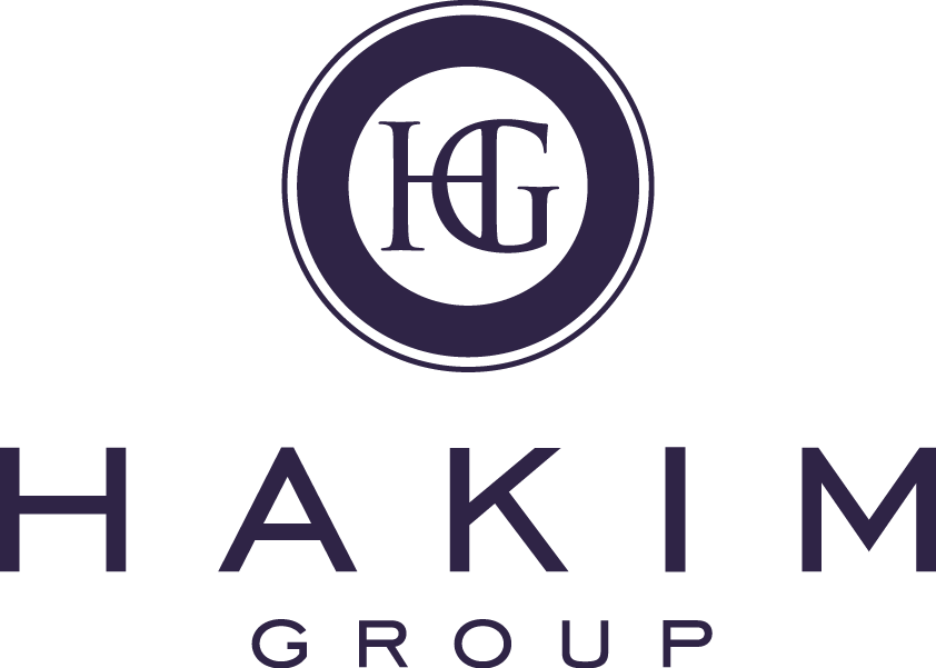 Logo of Hakim Group featuring a dark circle with HG in the center. The word HAKIM is written in large letters below, with GROUP in smaller letters underneath. The overall color scheme is dark blue.